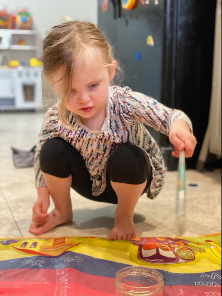 Toddler playing on a floor mat